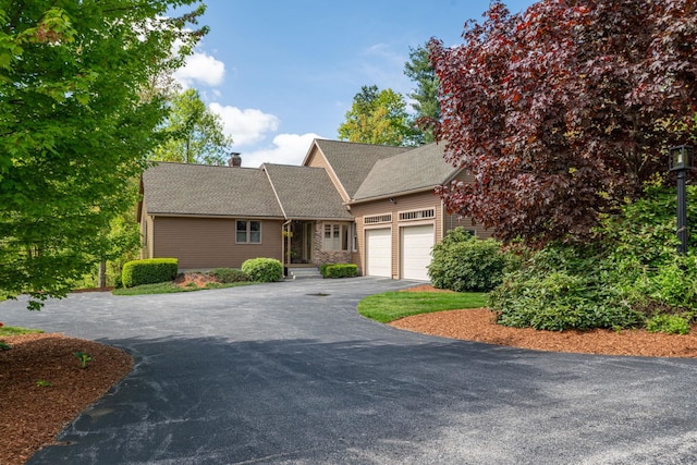 25 Golden Gate Dr, Hooksett, NH 03106 - view of front of house featuring asphalt driveway, a garage, and a chimney
