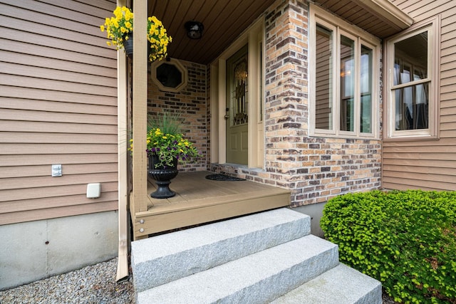 25 Golden Gate Dr, Hooksett, NH 03106 - doorway to property with covered porch and brick siding
