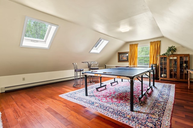 25 Golden Gate Dr, Hooksett, NH 03106 - recreation room with a baseboard radiator, a skylight, vaulted ceiling, and wood finished floors