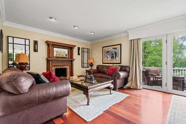 25 Golden Gate Dr, Hooksett, NH 03106 - living area with wood finished floors, crown molding, and a brick fireplace