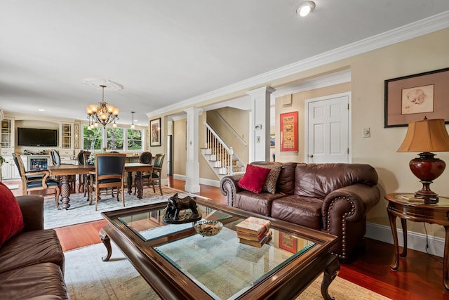25 Golden Gate Dr, Hooksett, NH 03106 - living room with ornamental molding, wood finished floors, ornate columns, a chandelier, and baseboards