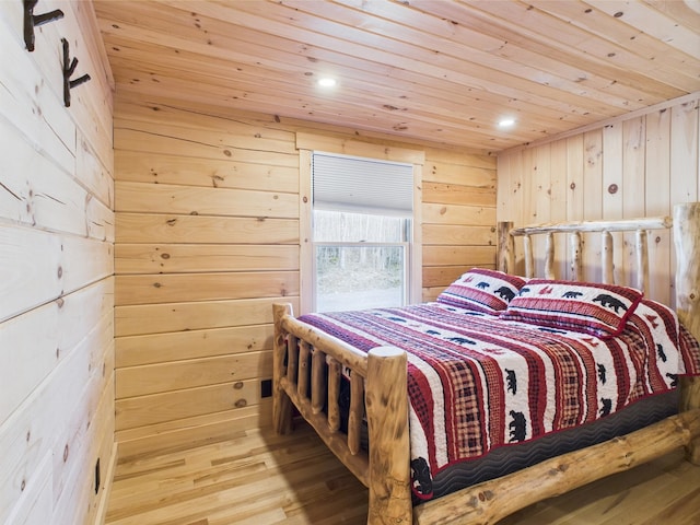 bedroom with wood ceiling, wooden walls, wood finished floors, and recessed lighting