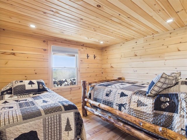 bedroom featuring wooden ceiling, wooden walls, wood finished floors, and recessed lighting