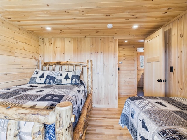 bedroom featuring wooden ceiling, light wood finished floors, wooden walls, and recessed lighting