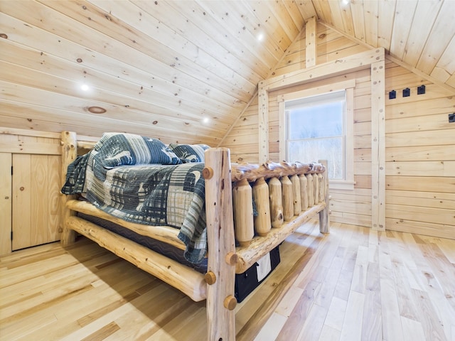 bedroom with vaulted ceiling, hardwood / wood-style floors, wooden walls, and wood ceiling