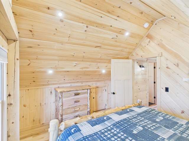 bedroom featuring wooden walls, lofted ceiling, wooden ceiling, and wood finished floors