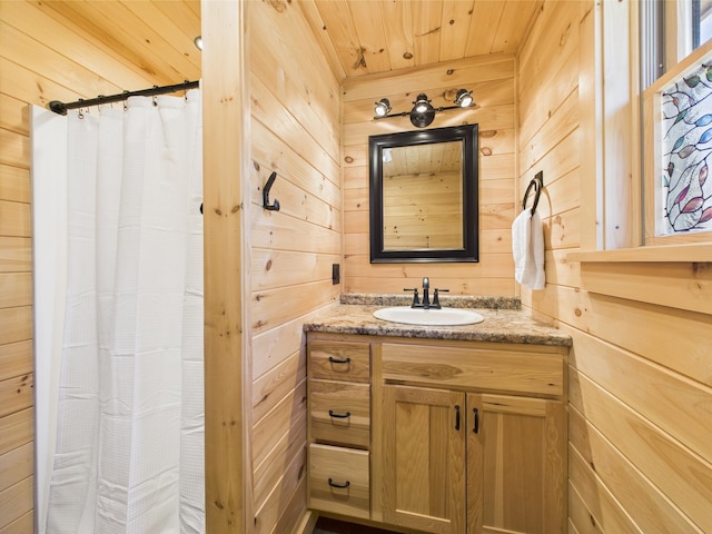 full bathroom featuring wooden walls, wooden ceiling, vanity, and curtained shower