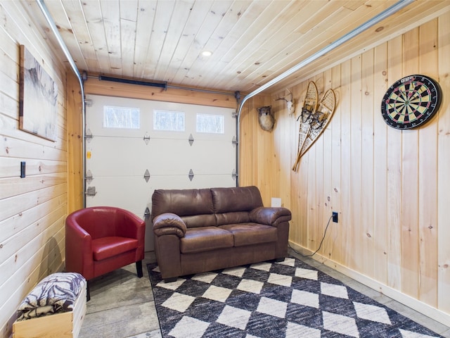 living room featuring wood walls, wood ceiling, and a garage
