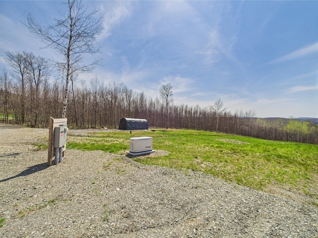 view of yard with a view of trees