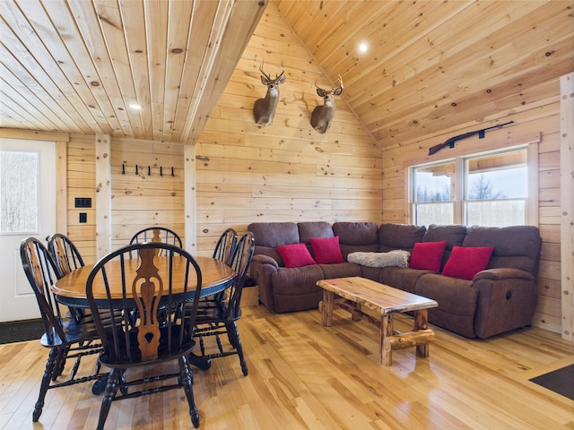 dining room with wood ceiling, wood walls, light wood-type flooring, recessed lighting, and vaulted ceiling