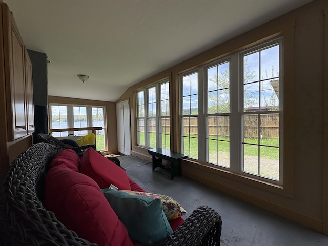 sunroom / solarium with vaulted ceiling, carpet flooring, and baseboards