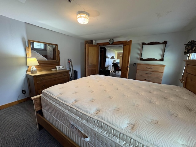 carpeted bedroom featuring baseboards