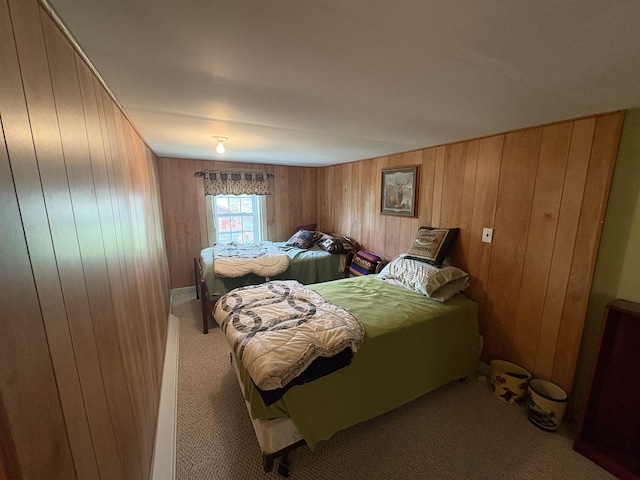 bedroom with carpet floors and wooden walls
