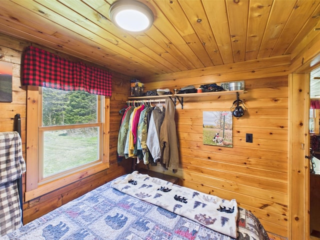bedroom with wood walls and wooden ceiling