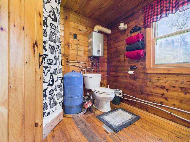 full bathroom with tankless water heater, wooden walls, toilet, hardwood / wood-style floors, and wood ceiling