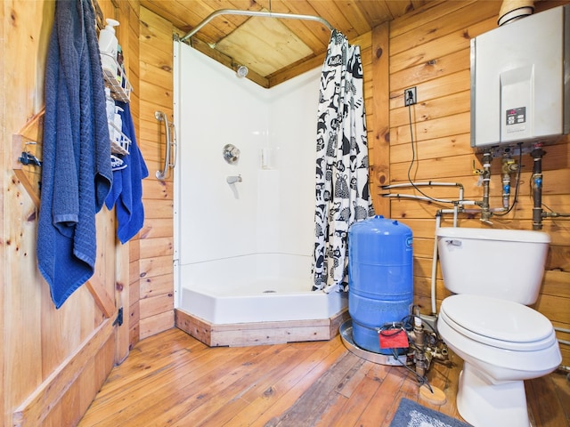 bathroom featuring tankless water heater, wood walls, wood-type flooring, a stall shower, and wooden ceiling