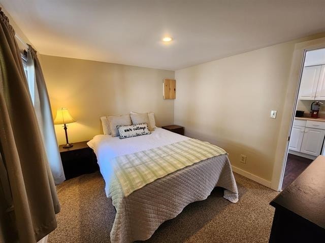 bedroom with dark carpet, baseboards, and recessed lighting