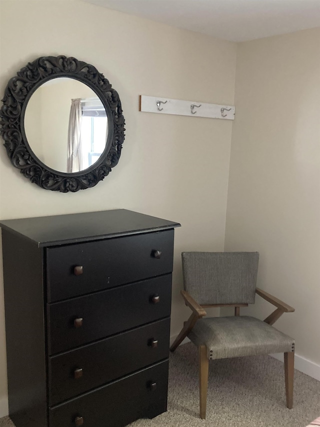 sitting room featuring carpet floors and baseboards