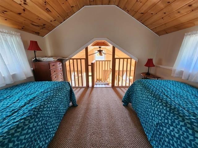 bedroom with vaulted ceiling, carpet flooring, and wood ceiling