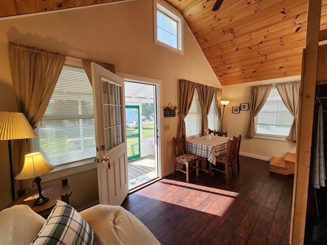 entryway featuring wooden ceiling, hardwood / wood-style floors, high vaulted ceiling, and baseboards