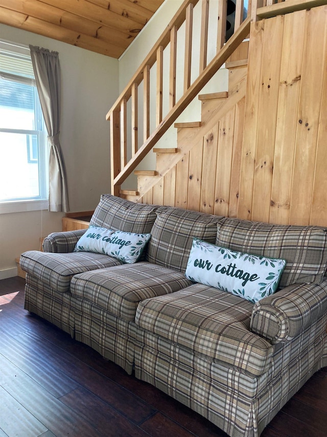 living room with wood finished floors, stairs, and baseboards