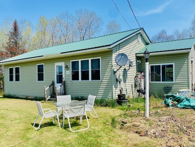 1810 Vt Route 102, Canaan, VT 05903 - rear view of house featuring entry steps, metal roof, and a lawn