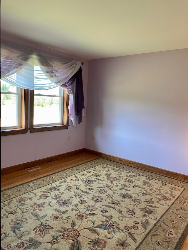1810 Vt Route 102, Canaan, VT 05903 - empty room featuring healthy amount of natural light, wood finished floors, and baseboards