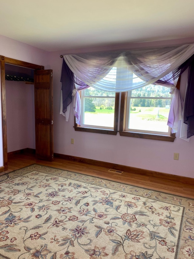 1810 Vt Route 102, Canaan, VT 05903 - unfurnished bedroom featuring wood finished floors and baseboards