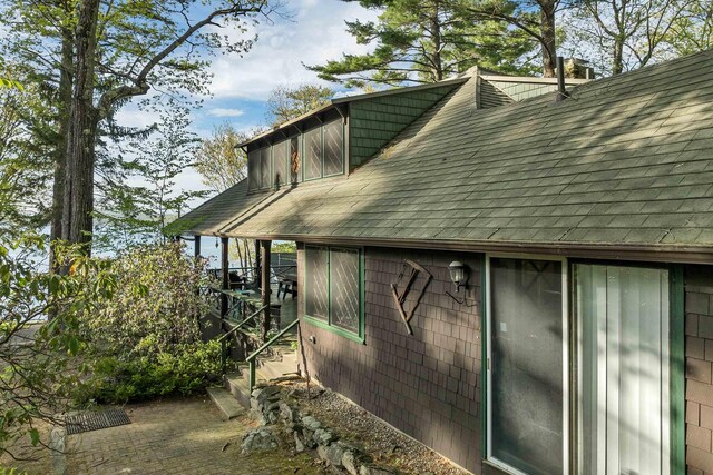148 Lucerne Ave Unit 15, Laconia, NH 03246 - view of side of home with a shingled roof and a chimney