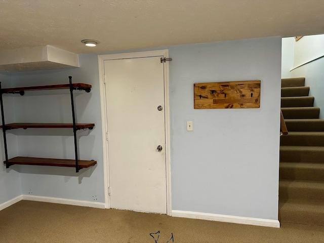 stairs with carpet floors and baseboards