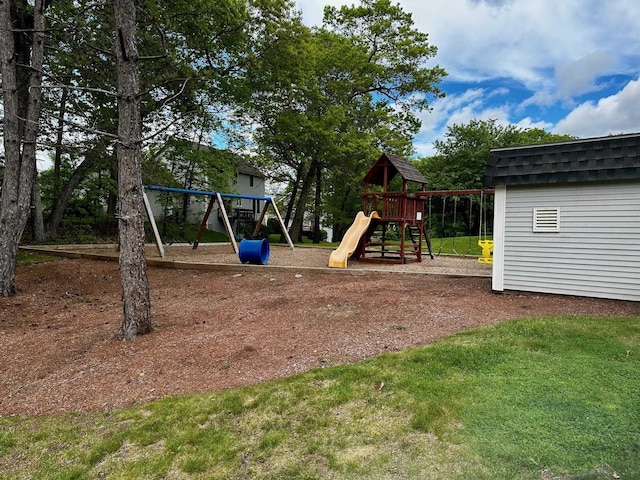 communal playground featuring an outbuilding, a lawn, and a storage shed