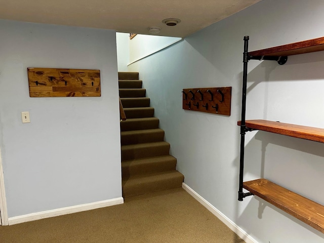 stairway with carpet and baseboards