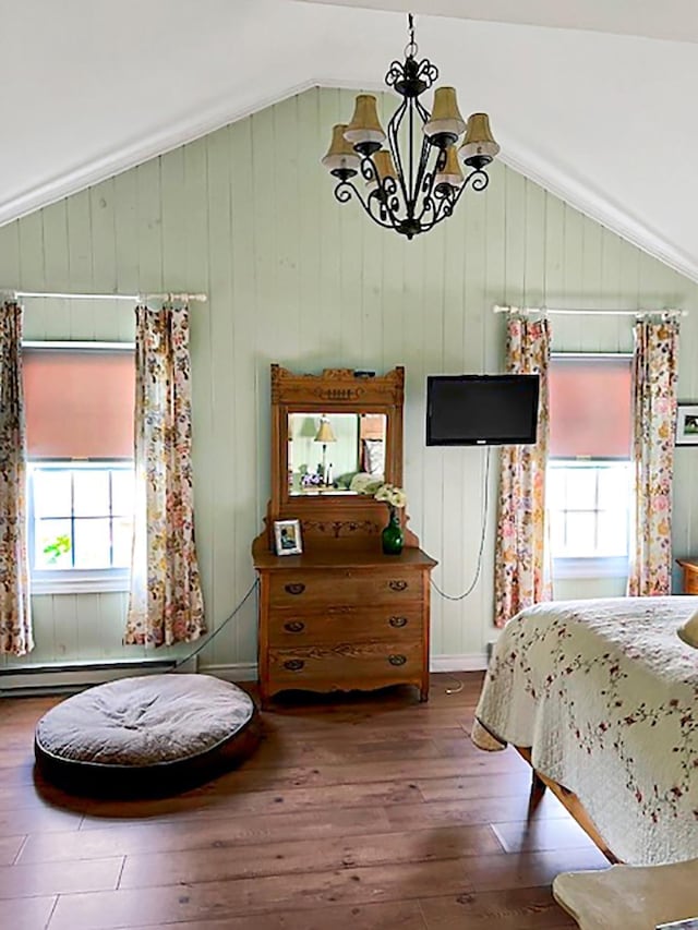 121 Platt Rd, Highgate, VT 05459 - bedroom featuring lofted ceiling, multiple windows, a chandelier, hardwood / wood-style flooring, and wooden walls