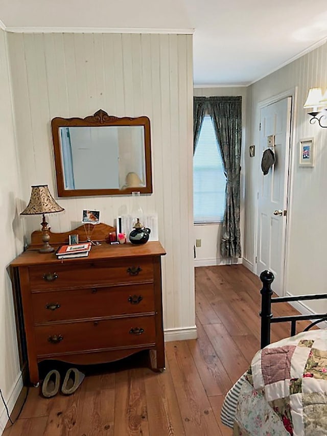 121 Platt Rd, Highgate, VT 05459 - bedroom featuring wood-type flooring, ornamental molding, baseboards, and wooden walls