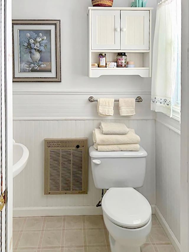 121 Platt Rd, Highgate, VT 05459 - bathroom featuring toilet, baseboards, and wainscoting