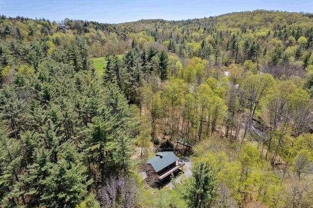 view from above of property with a heavily wooded area