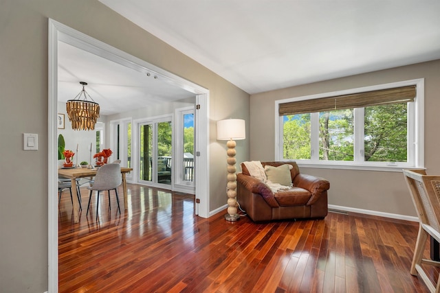 204 Chase Way, Manchester, NH 03104 - living area featuring baseboards, a chandelier, and wood finished floors
