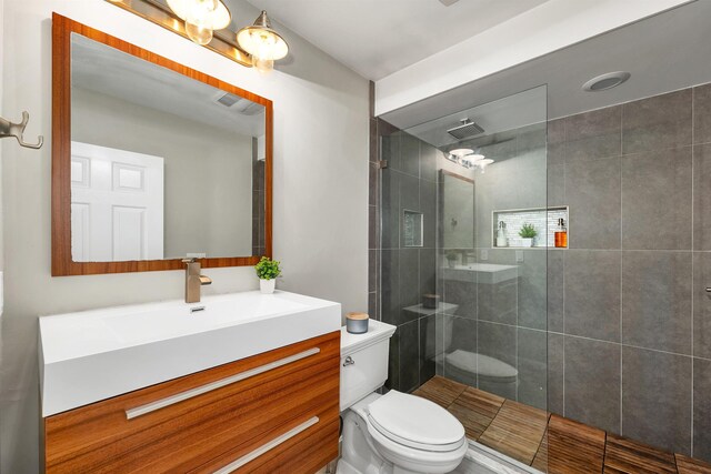 204 Chase Way, Manchester, NH 03104 - bathroom featuring toilet, walk in shower, and vanity
