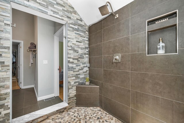 204 Chase Way, Manchester, NH 03104 - full bathroom featuring tile patterned floors, tiled shower, baseboards, and a walk in closet