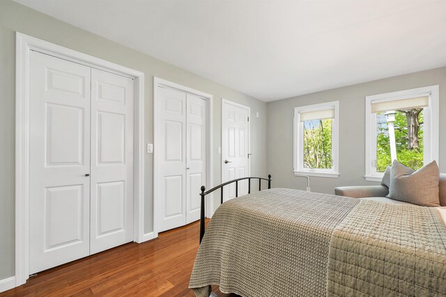 204 Chase Way, Manchester, NH 03104 - bedroom with multiple closets, dark wood-style flooring, and baseboards