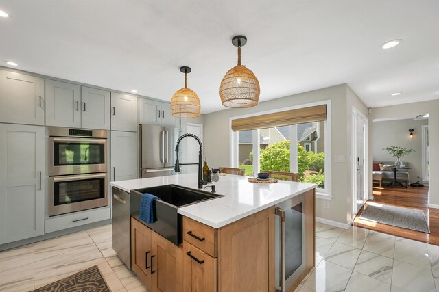204 Chase Way, Manchester, NH 03104 - kitchen with appliances with stainless steel finishes, a sink, wine cooler, light marble finish flooring, and recessed lighting