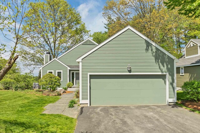 204 Chase Way, Manchester, NH 03104 - view of front of property with a chimney, a front lawn, an attached garage, and driveway