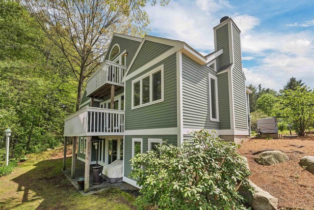 204 Chase Way, Manchester, NH 03104 - rear view of property featuring a balcony and a chimney
