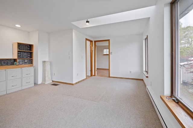 150 Stevens Rd, Lebanon, NH 03766 - unfurnished living room featuring baseboard heating, light colored carpet, and baseboards