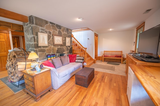 living area featuring wood finished floors and stairway