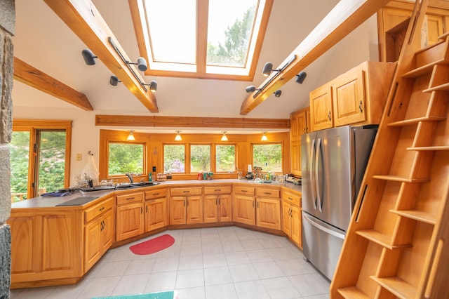 kitchen with freestanding refrigerator, open shelves, beam ceiling, light tile patterned floors, and a peninsula