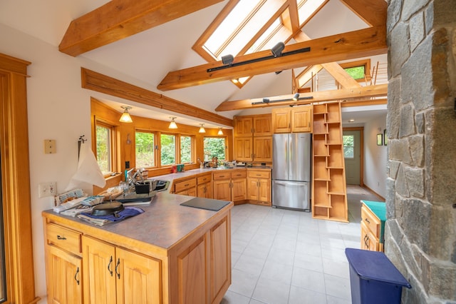 kitchen with freestanding refrigerator, open shelves, a peninsula, a sink, and a skylight