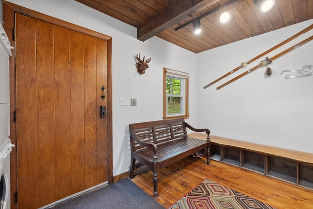 46 Crestwood Dr, Conway, NH 03860 - sitting room featuring stacked washer and clothes dryer, wooden ceiling, wood finished floors, and beam ceiling