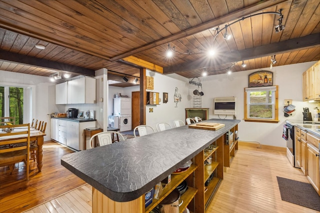 46 Crestwood Dr, Conway, NH 03860 - kitchen with track lighting, wooden ceiling, open shelves, dark countertops, and baseboards