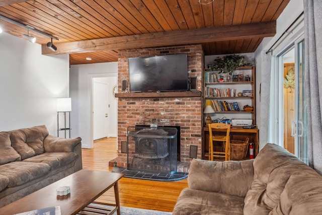 46 Crestwood Dr, Conway, NH 03860 - living room featuring wood ceiling, hardwood / wood-style flooring, beamed ceiling, a wood stove, and rail lighting